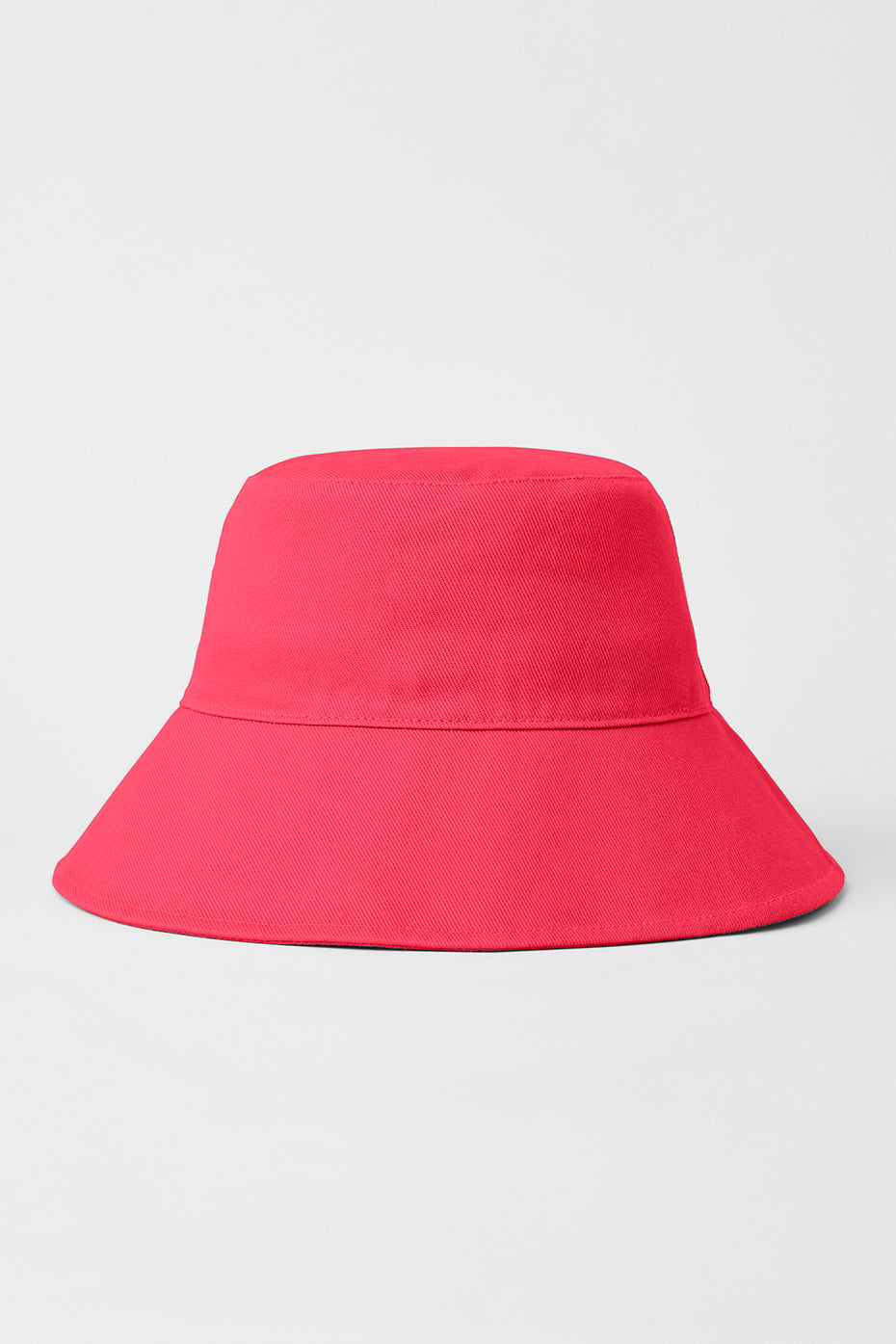 Weekender bucket hat rolled up next to sunglasses and keys for travel