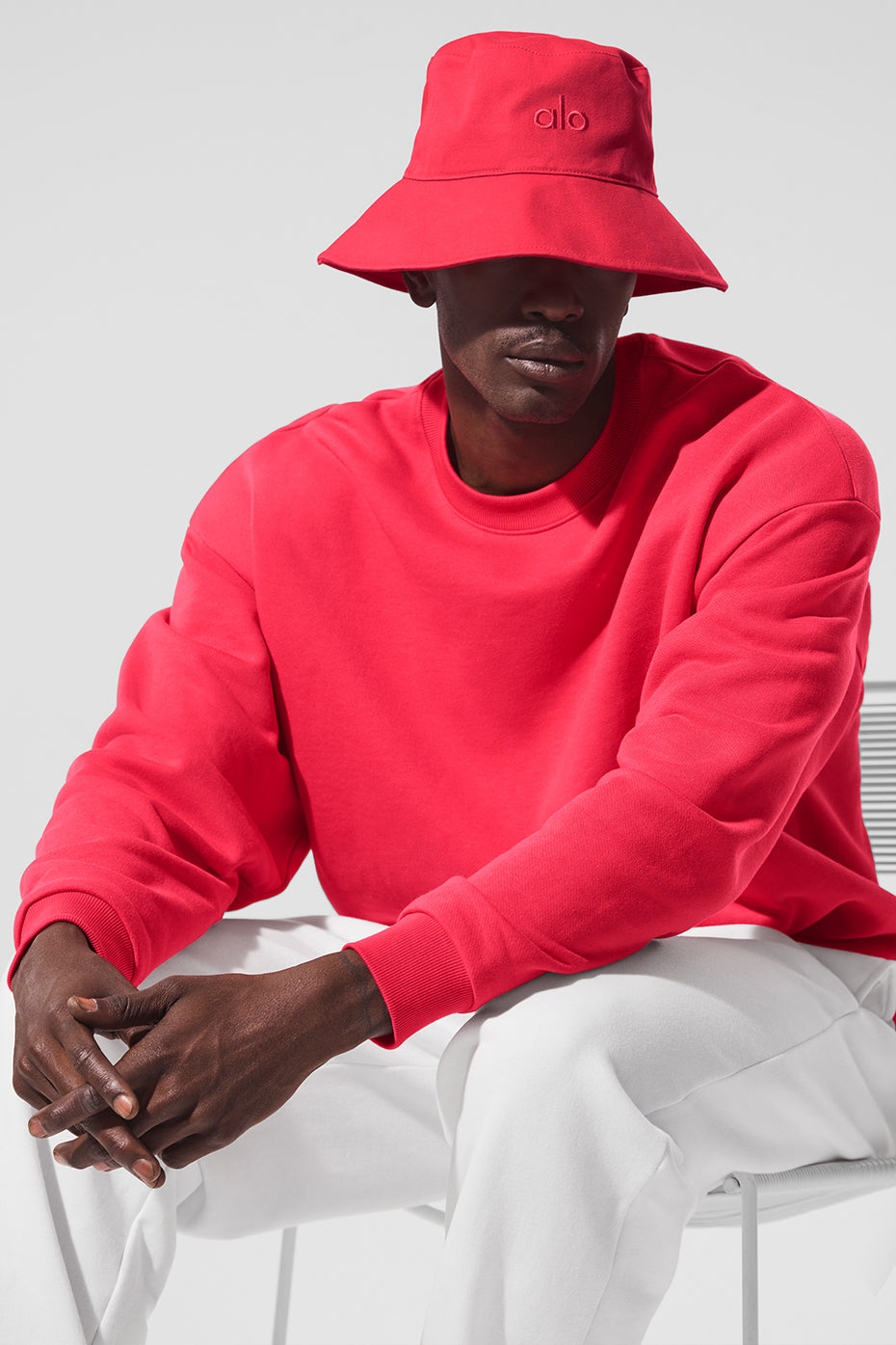 Side view of candy red bucket hat on a mannequin head in natural light