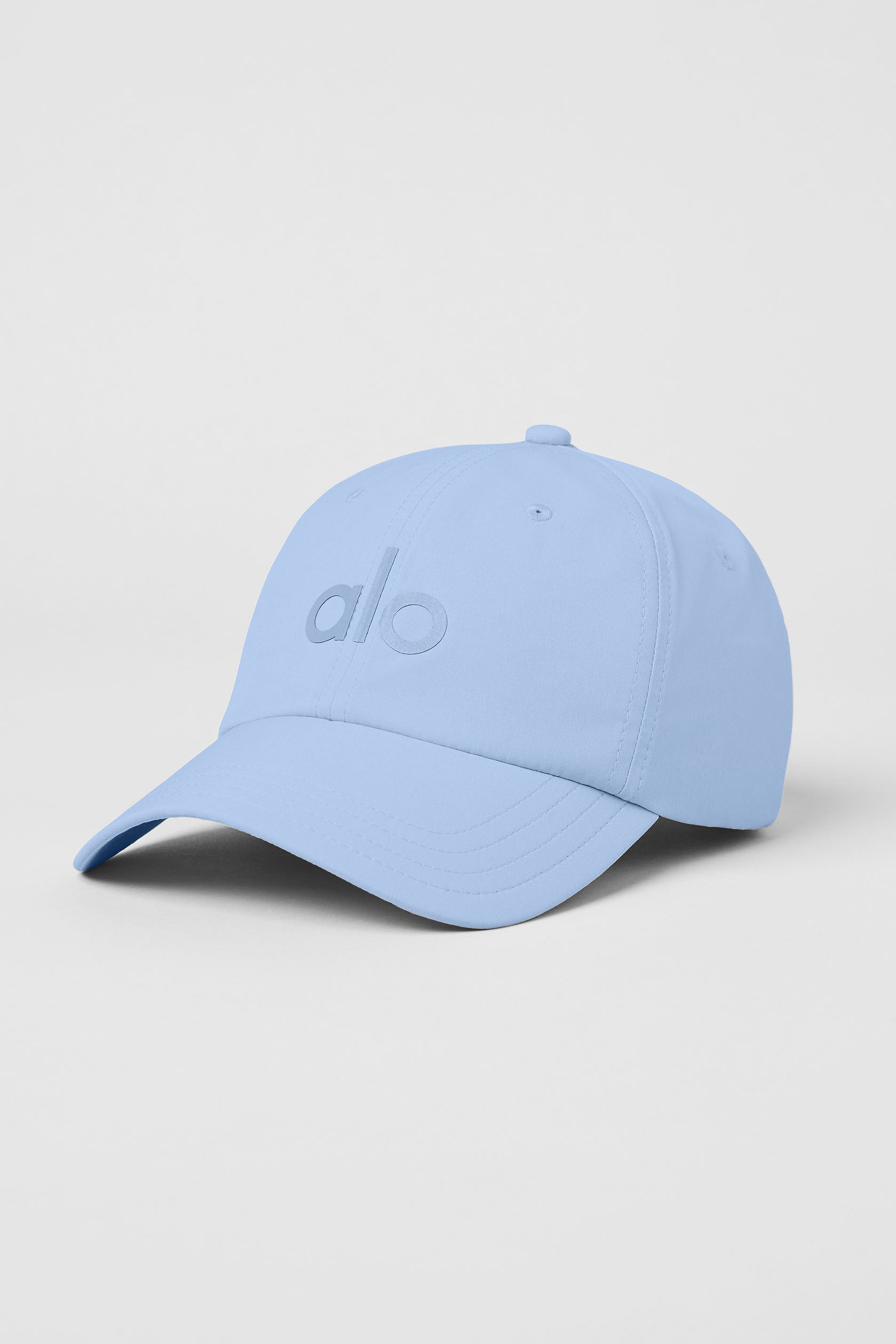 Seashell Blue athletic hat with curved brim on a model during outdoor activity