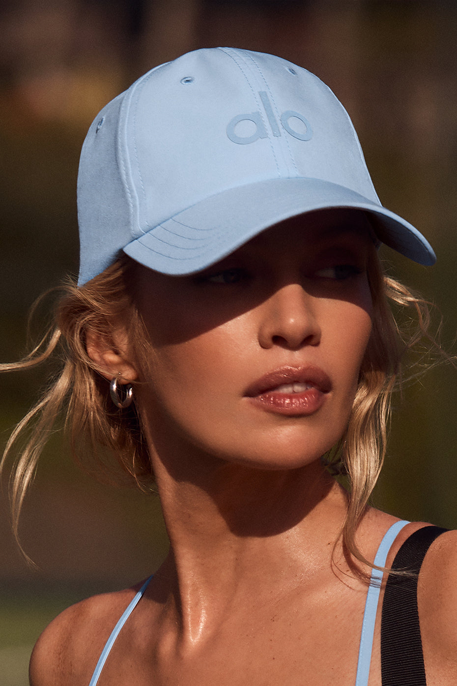 Seashell Blue athletic hat with curved brim on a model during outdoor activity