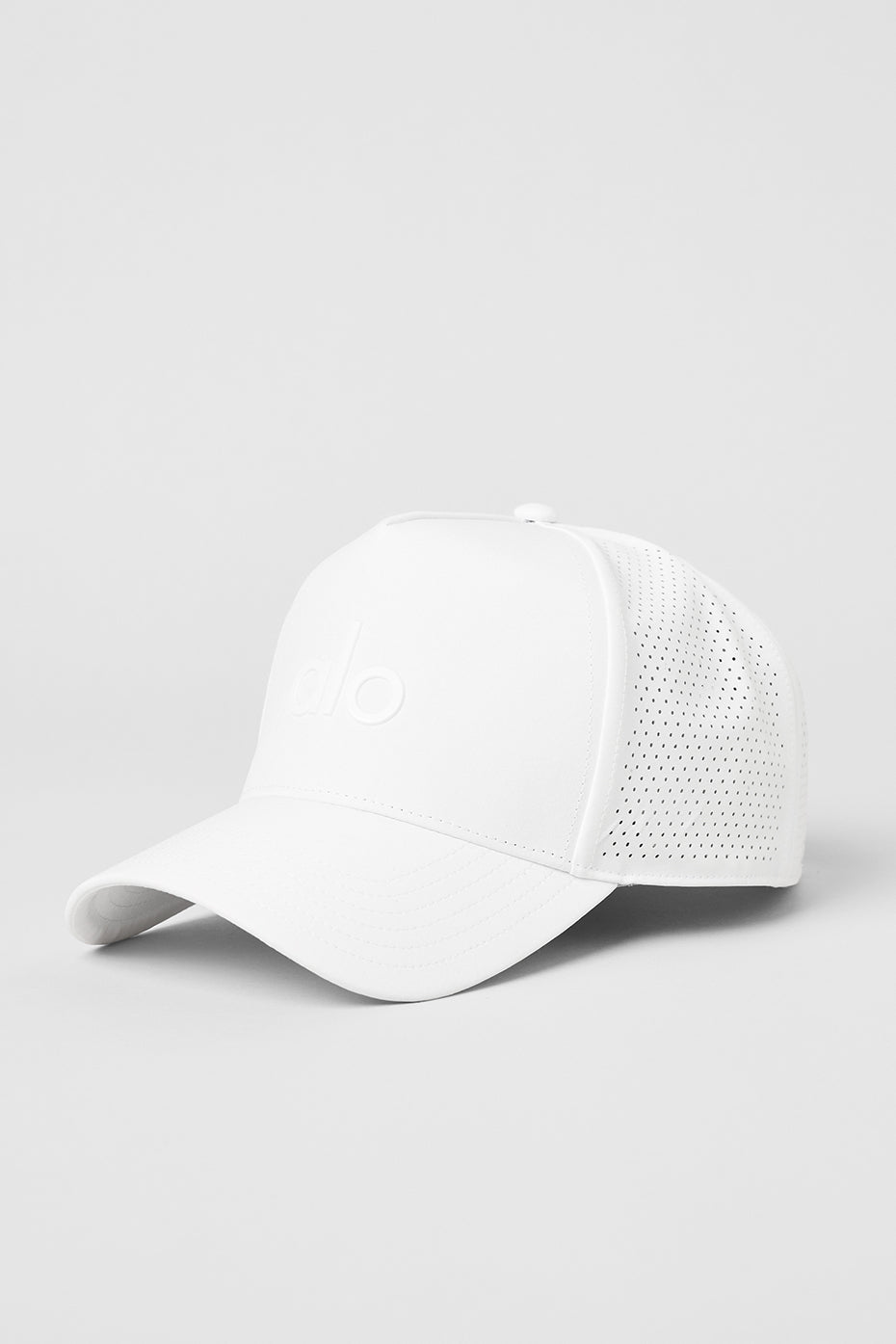 Close-up of white performance trucker hat highlighting breathable perforated back panels