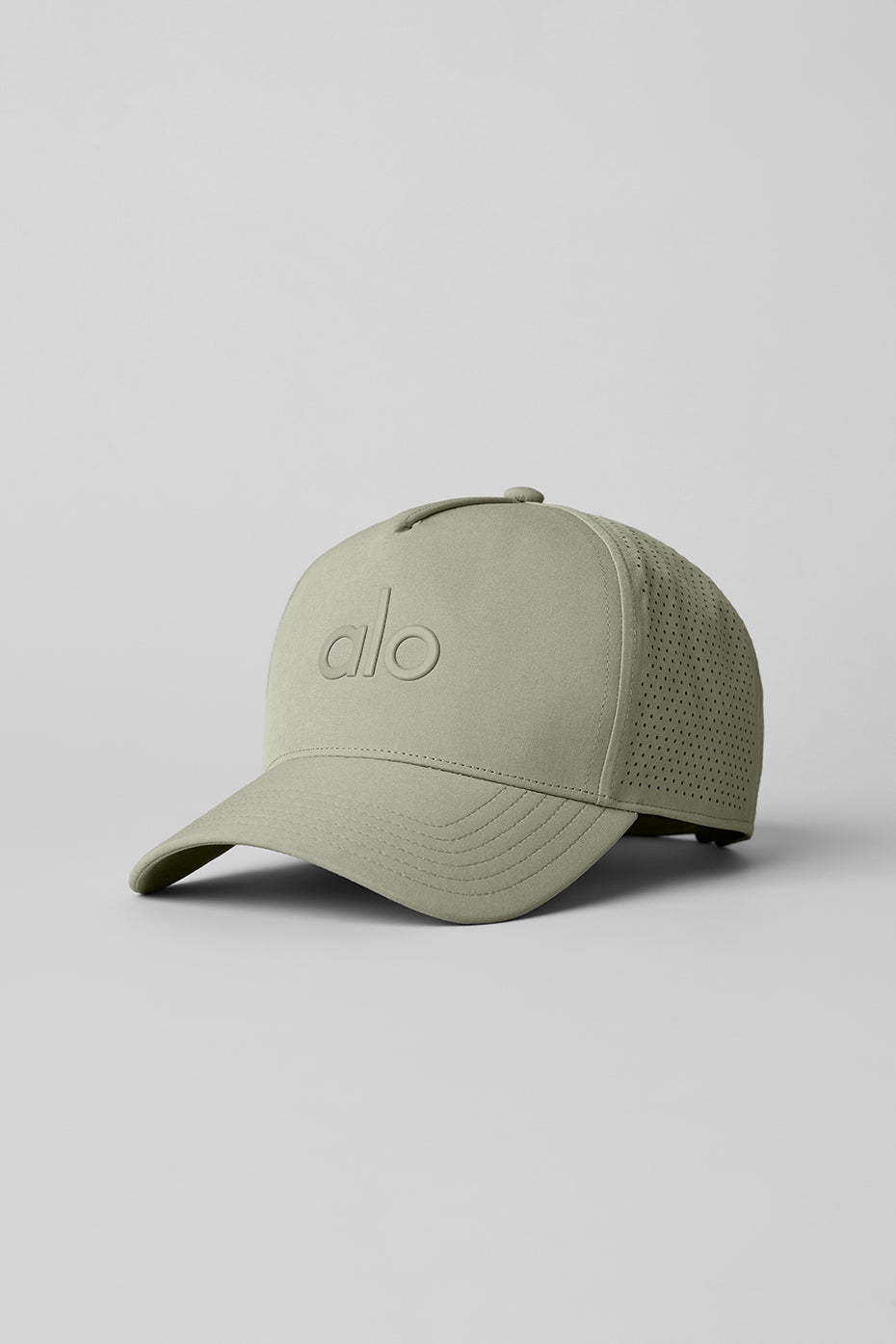 Front view of the Performance District Trucker Hat highlighting its structured crown and limestone color