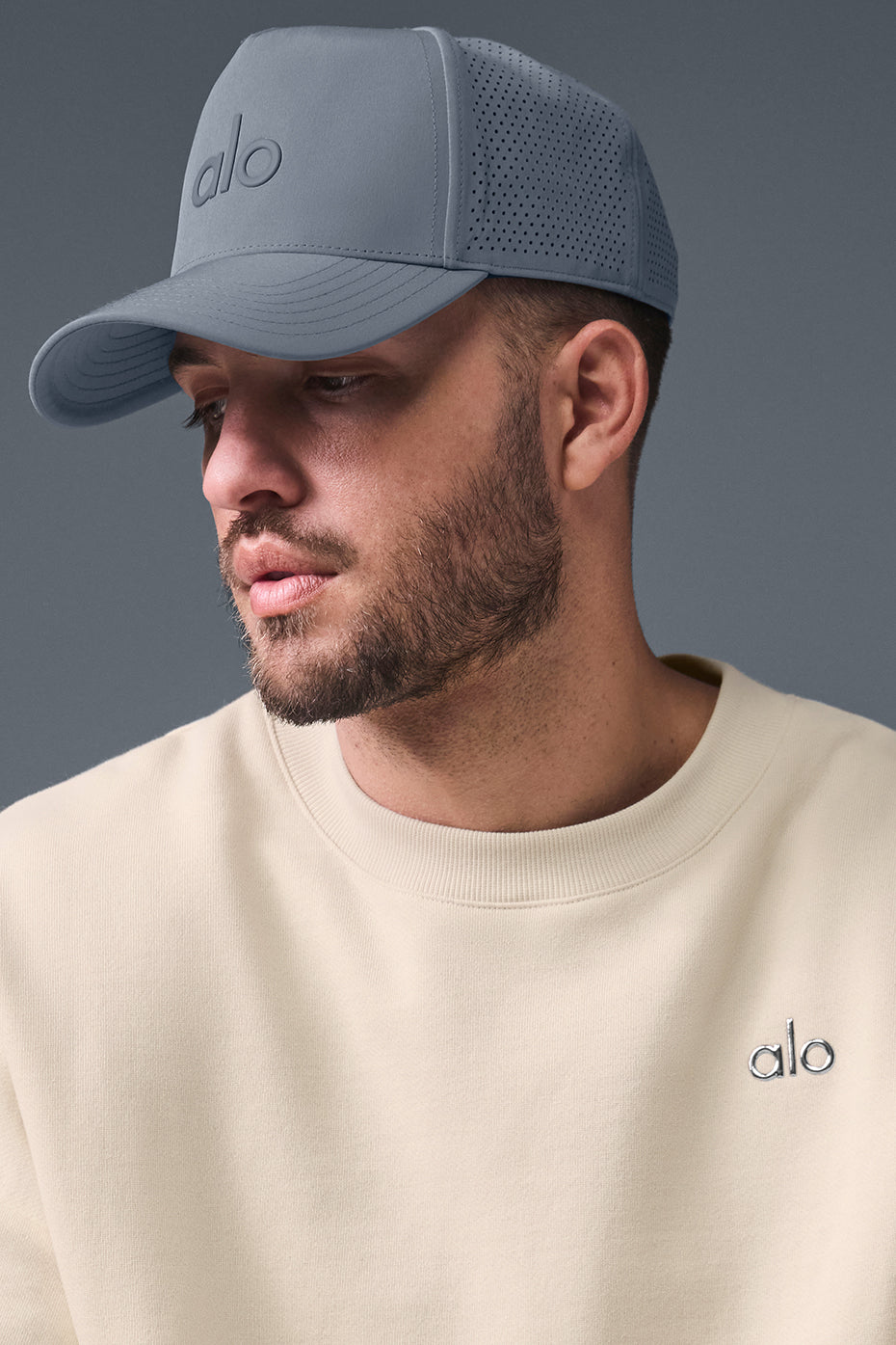 Front view of the Performance District Trucker Hat in Steel Grey, showcasing its structured design.