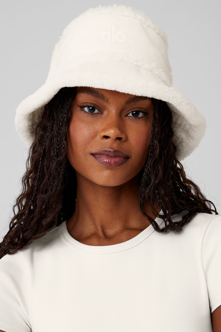 Cozy ivory bucket hat styled with the brim up, ideal for winter fashion.