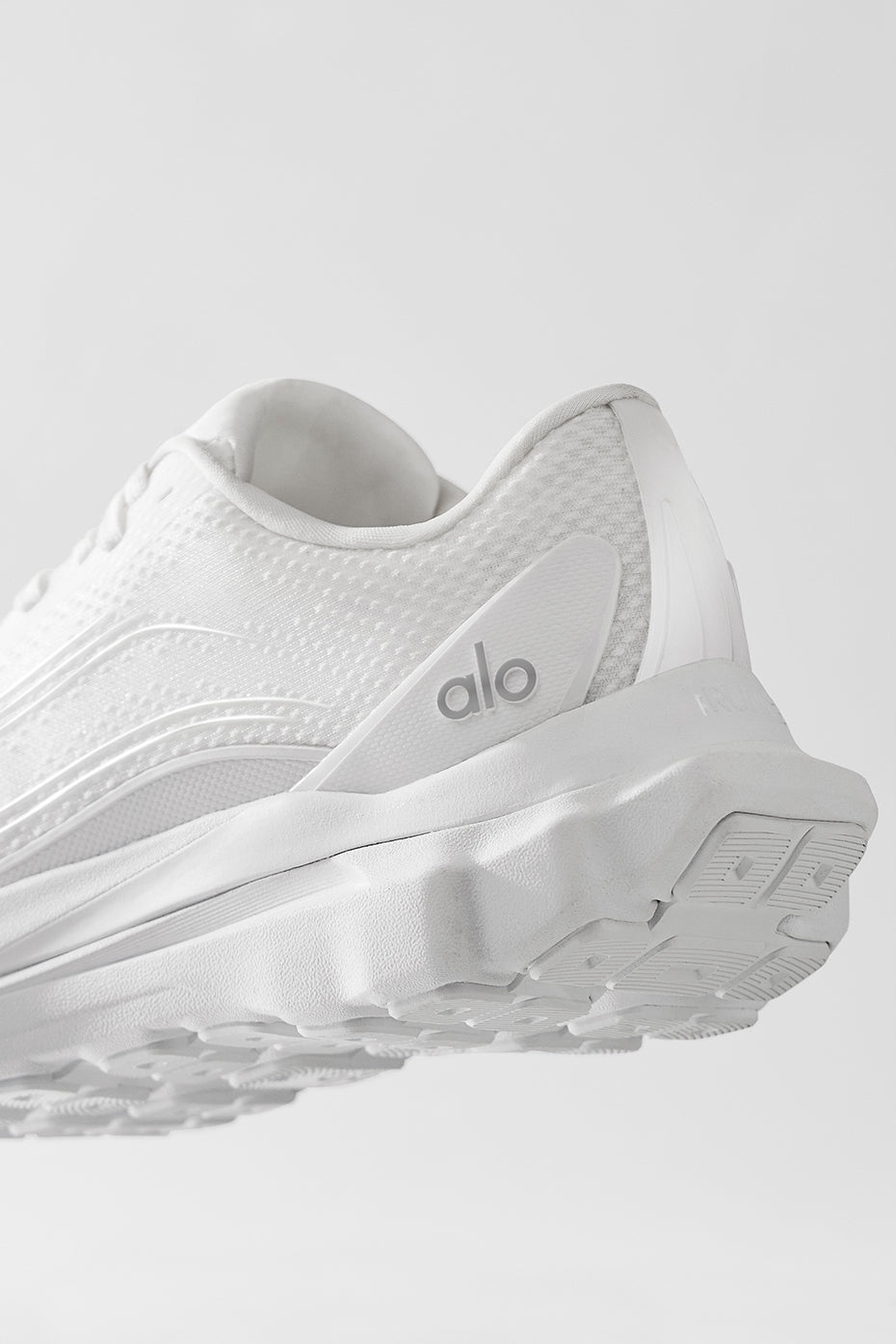 Runner wearing ALO Shoes on trail, emphasizing stability and support