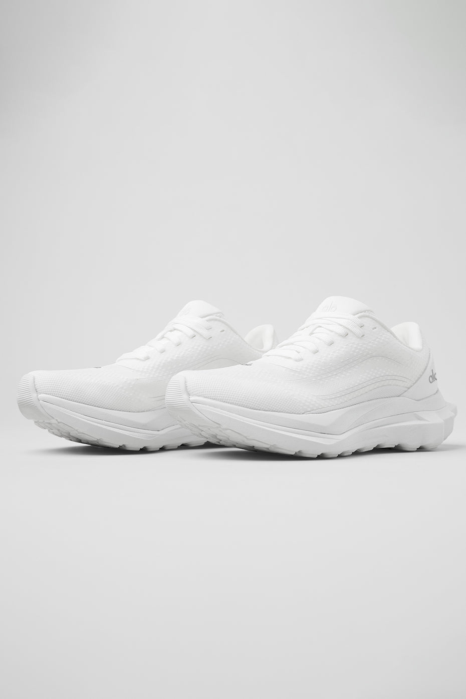 Side view of ALO Runner shoes highlighting dual-density midsole for responsiveness