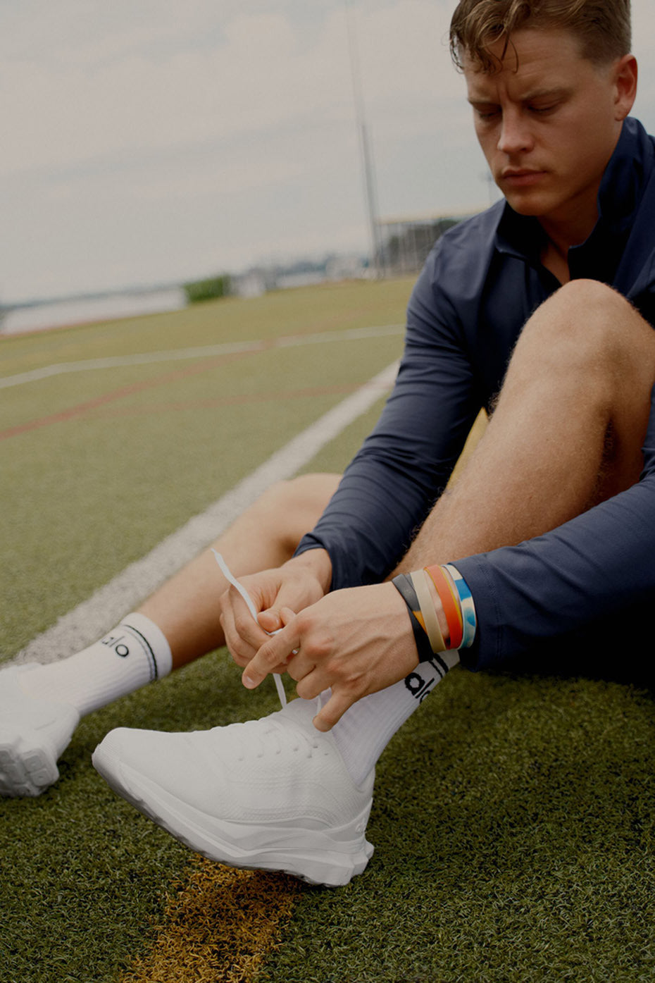 Close-up of ALO Runner shoes showing stability heel clip and breathable mesh upper