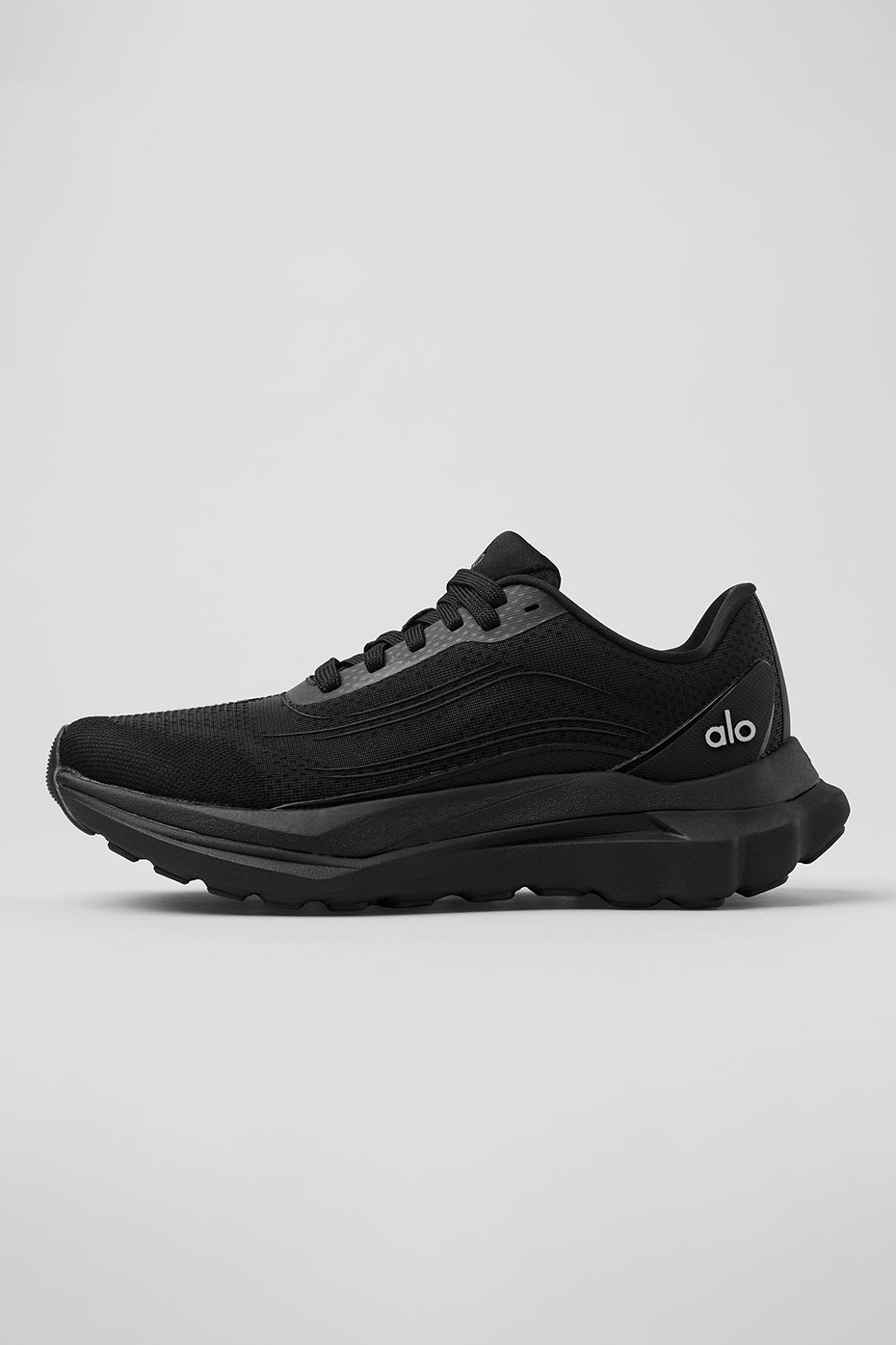 Side view of ALO Runner stability performance shoes on a trail.