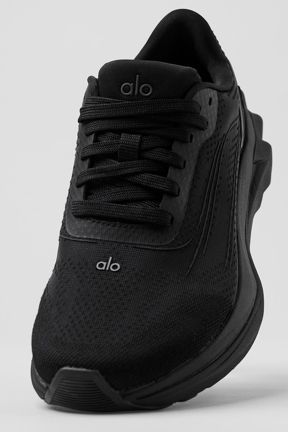 Side view of ALO Runner stability performance shoes on a trail.
