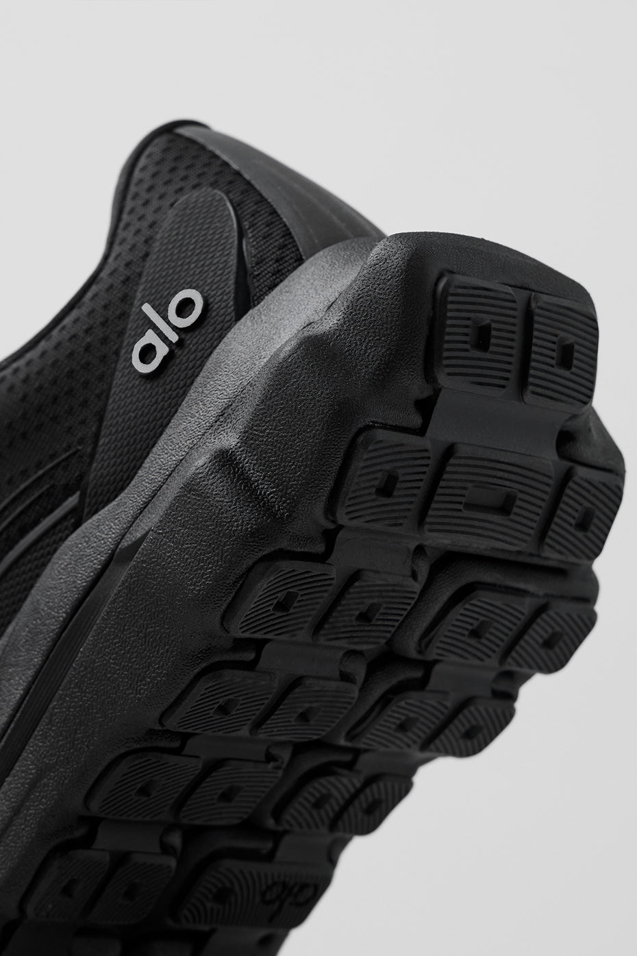 Close-up of breathable mesh upper of ALO Runner shoes.