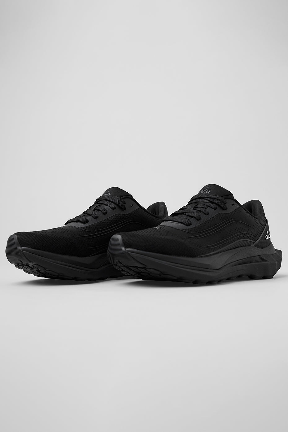 Side view of ALO Runner stability performance shoes on a trail.
