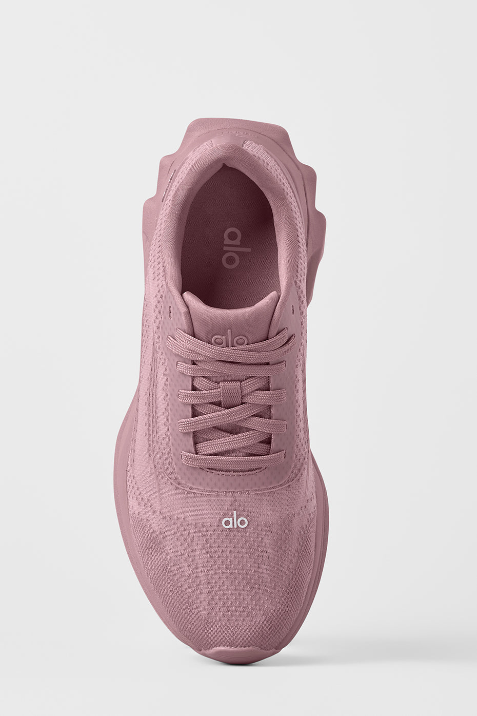 ALO Runner performance sneakers side view on urban pavement