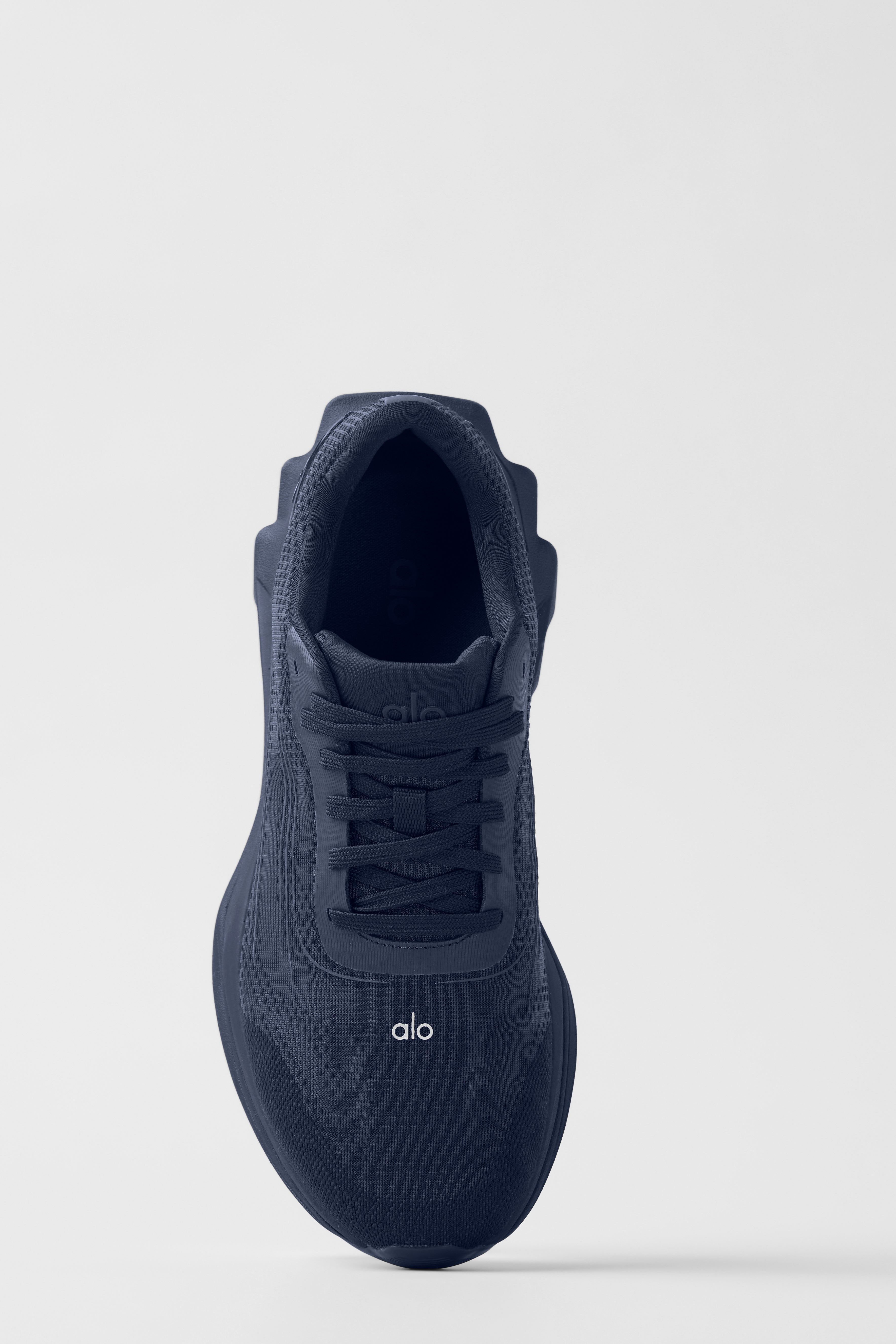 ALO Performance Runner shoes viewed from the side, highlighting the stabilizing heel clip.