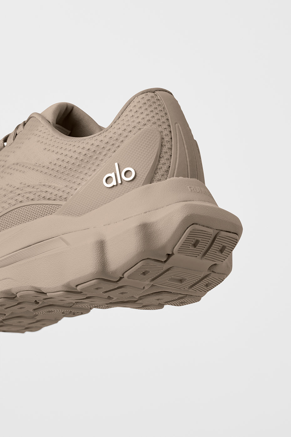 ALO Gravel Runner on gravel trail, highlighting dual-density midsole