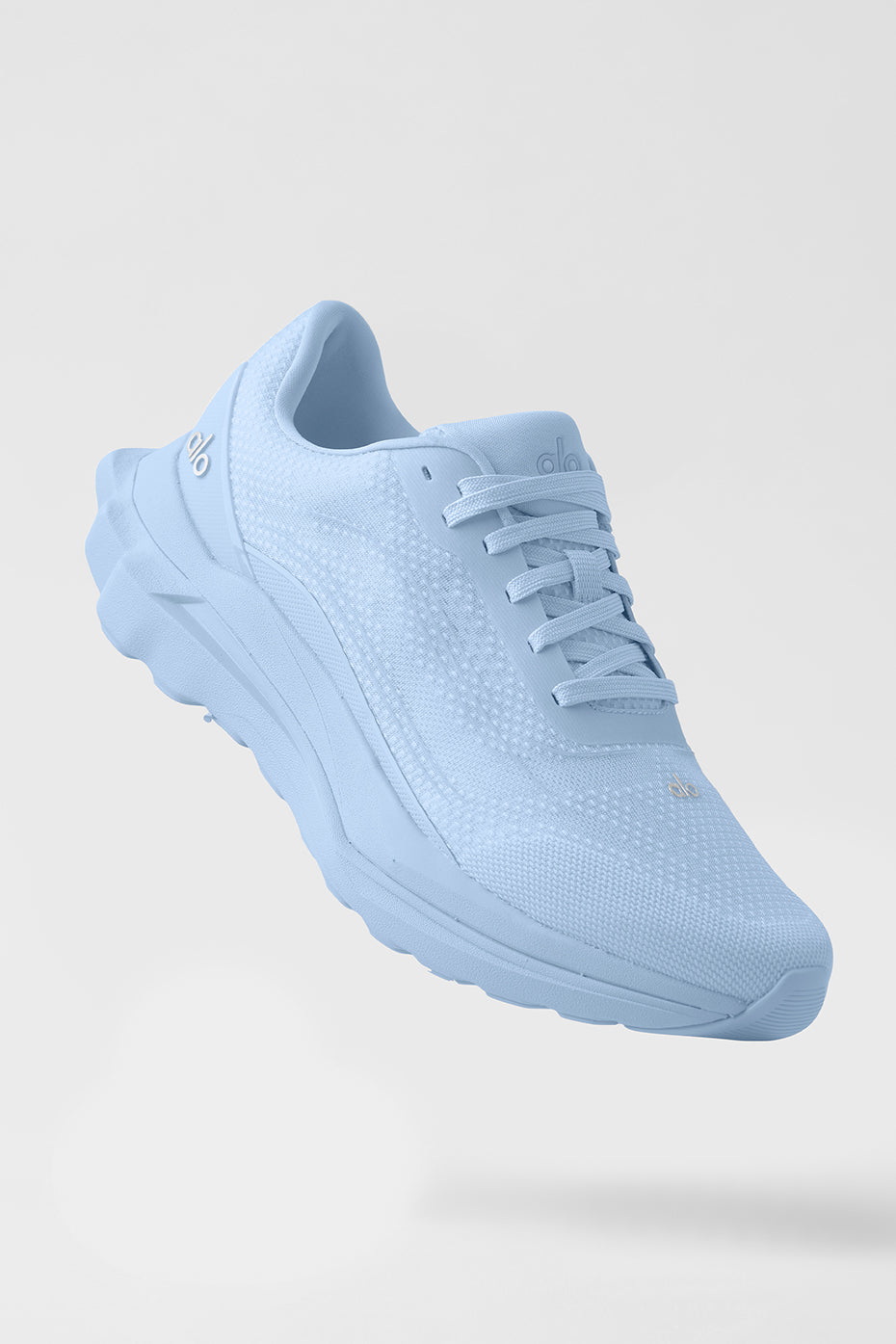 ALO Runner Seashell Blue side profile on trail, highlighting recycled mesh upper