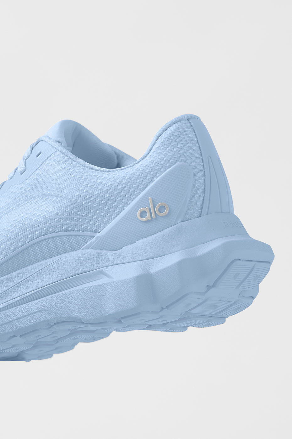 ALO Runner Seashell Blue side profile on trail, highlighting recycled mesh upper