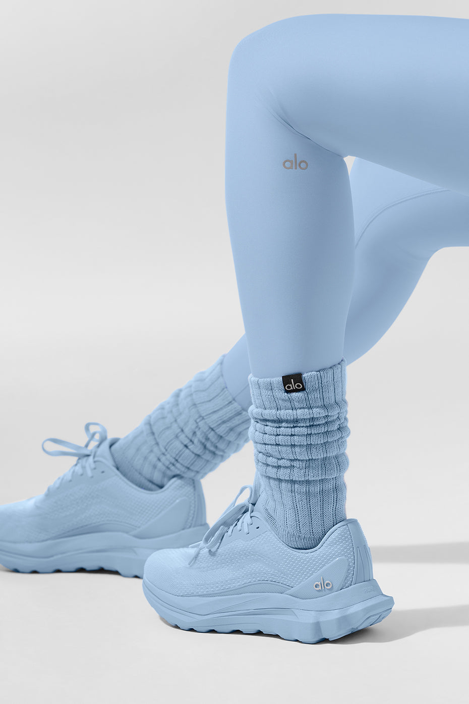 Runner wearing ALO shoes on mixed terrain, demonstrating lightweight performance