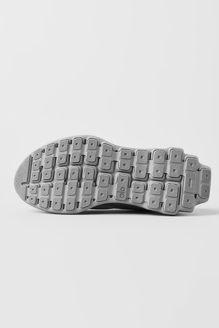 ALO Runner performance sneakers on a trail, highlighting their versatility and comfort.