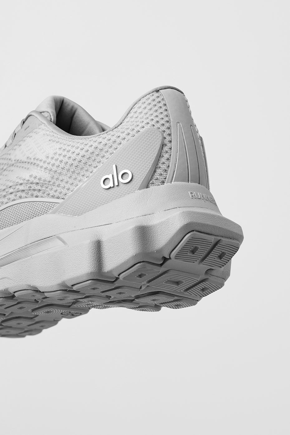 Close-up of the stabilizing heel clip on ALO Runner sneakers, designed for support.