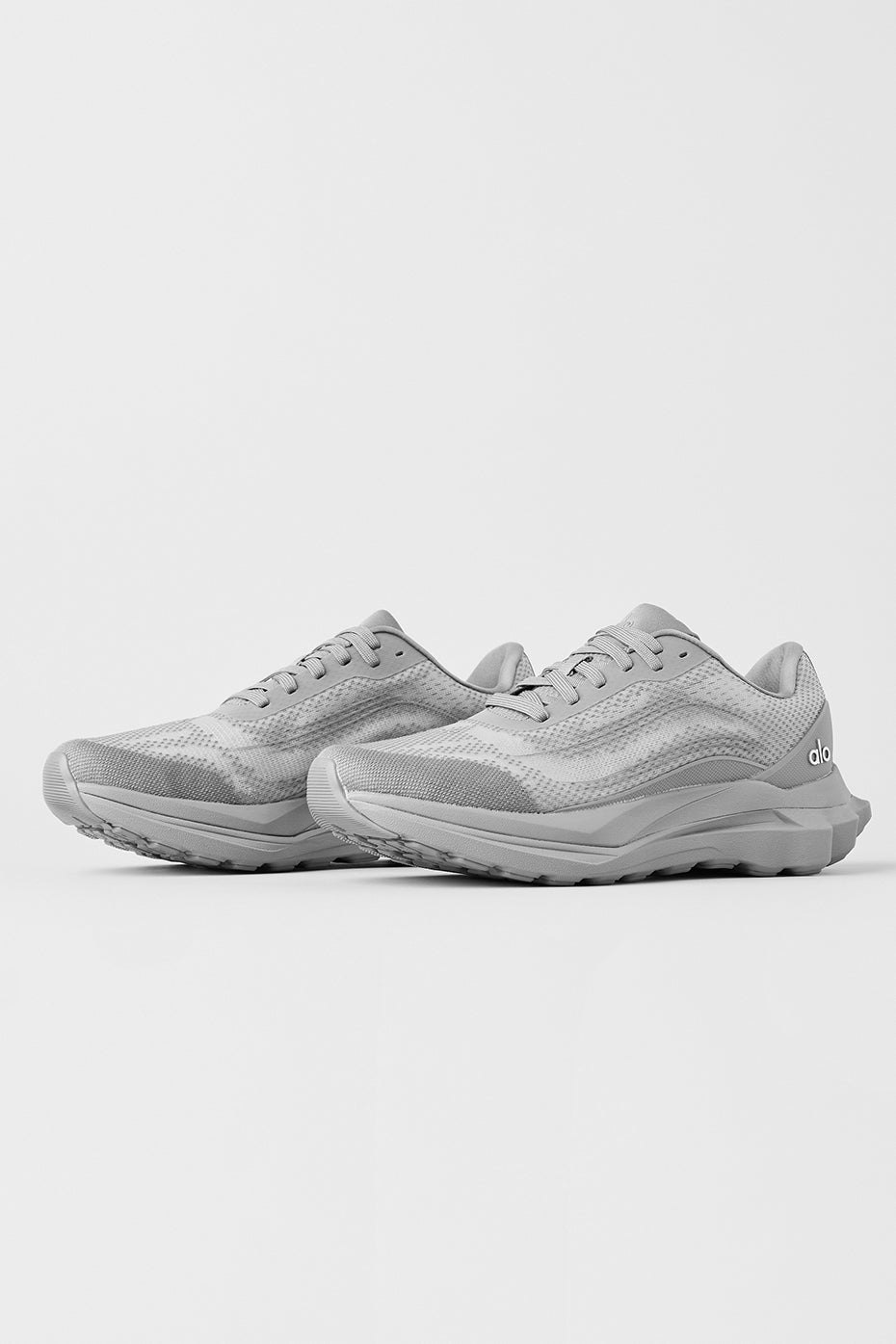 ALO Runner performance sneakers on a trail, highlighting their versatility and comfort.