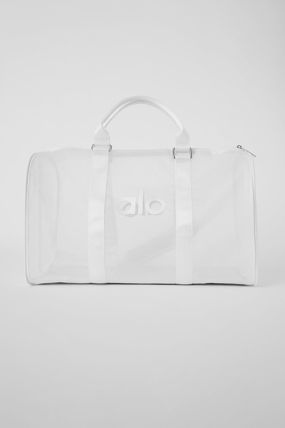 Person carrying sheer duffle with shoulder strap, ready for weekend trip