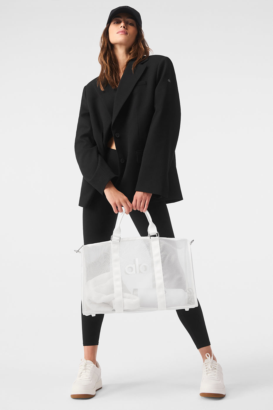 Close-up of sheer duffle bag showing see-through material and white accents