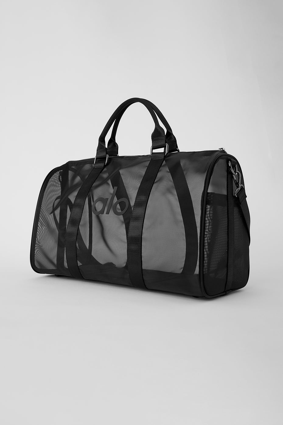 Close-up of the zipper and handles on the black duffle bag.