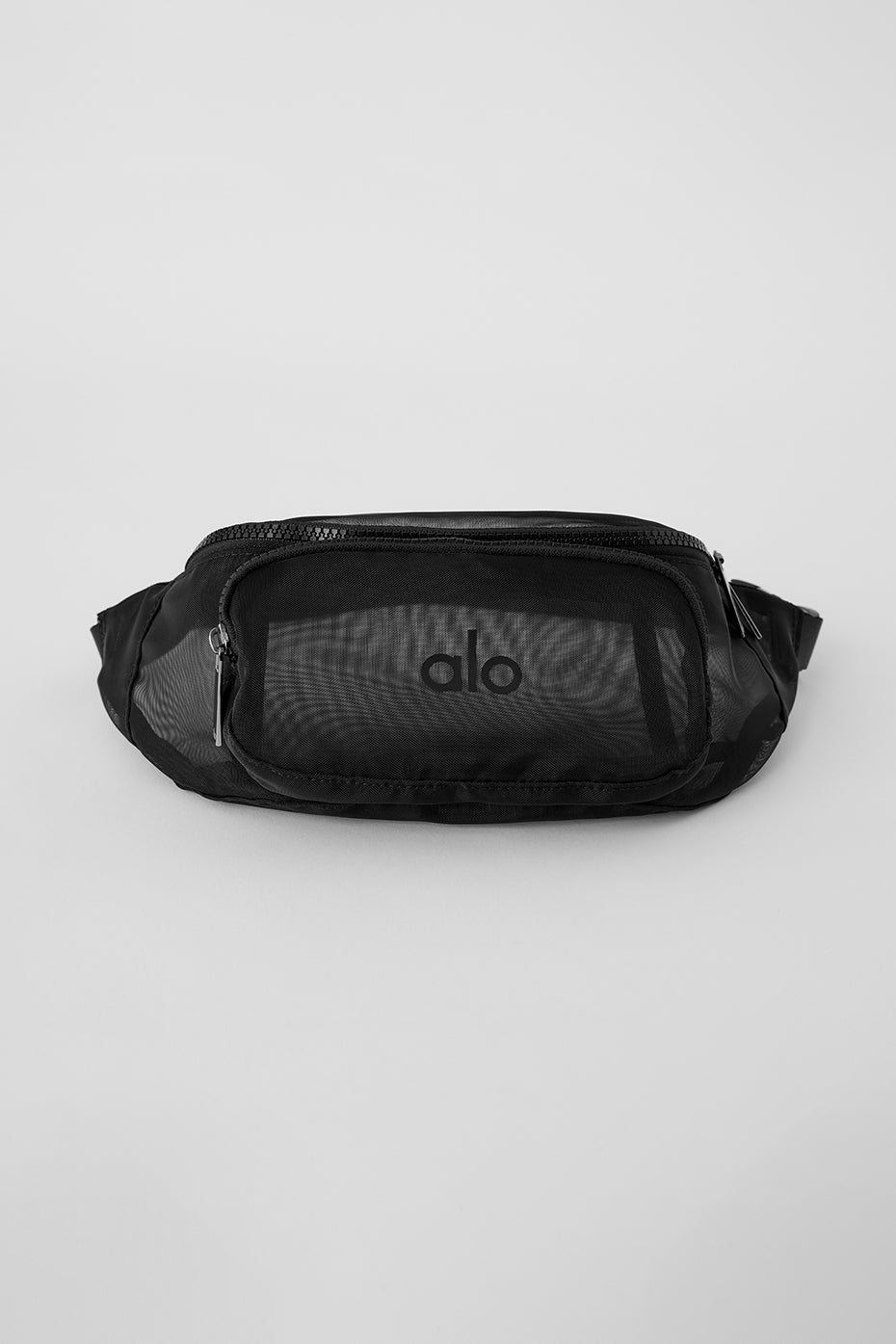 Side view of the black fanny pack worn across the chest at a festival.
