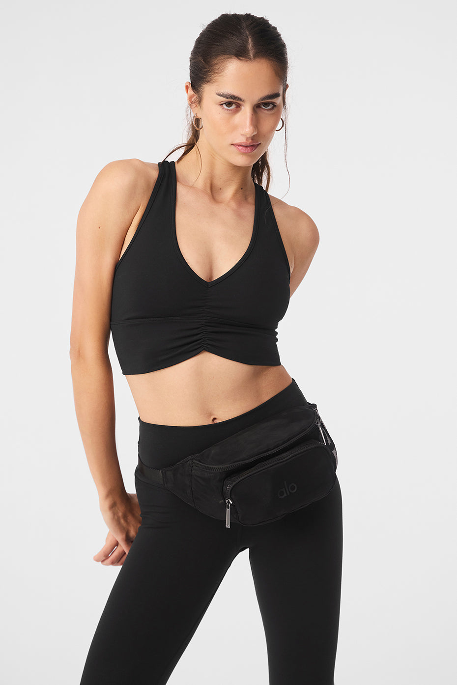 Side view of the black fanny pack worn across the chest at a festival.