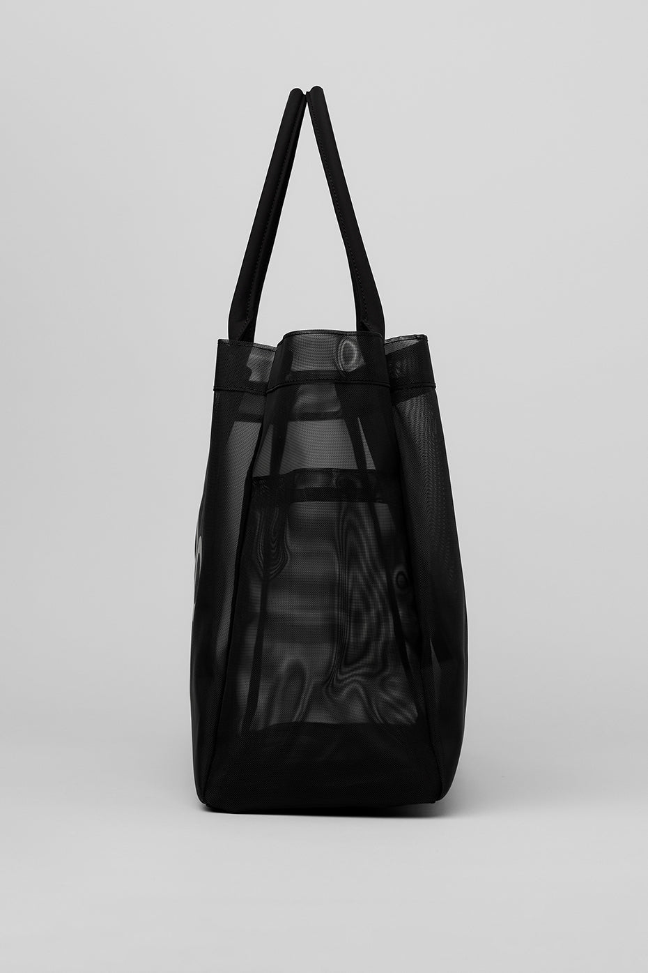 Close-up of the black mesh bucket bag showcasing its adjustable shoulder strap and pockets.