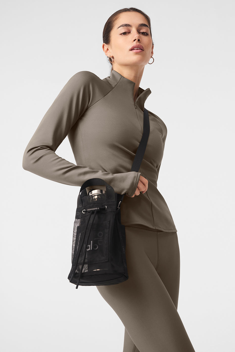 Black mesh crossbody bucket bag with top handles and drawstring closure, perfect for casual outings.