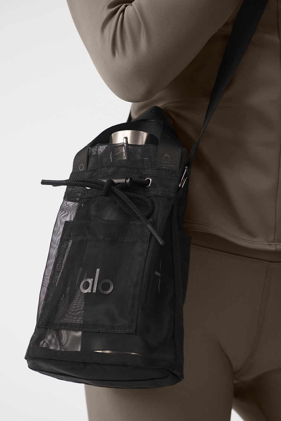 Close-up of the black mesh bucket bag showcasing its adjustable shoulder strap and pockets.