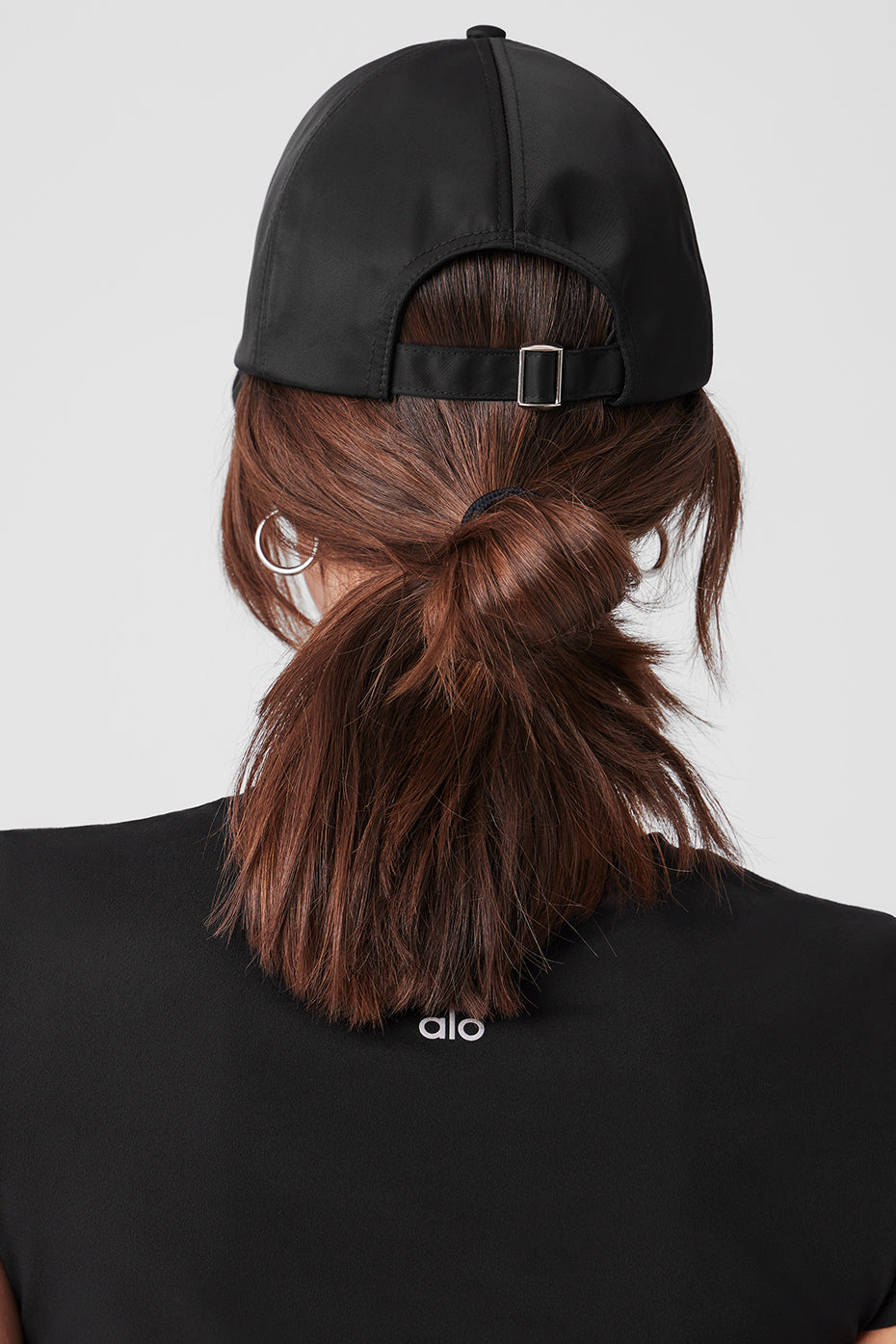Model wearing the satin cap with a chic outfit, demonstrating its versatility.