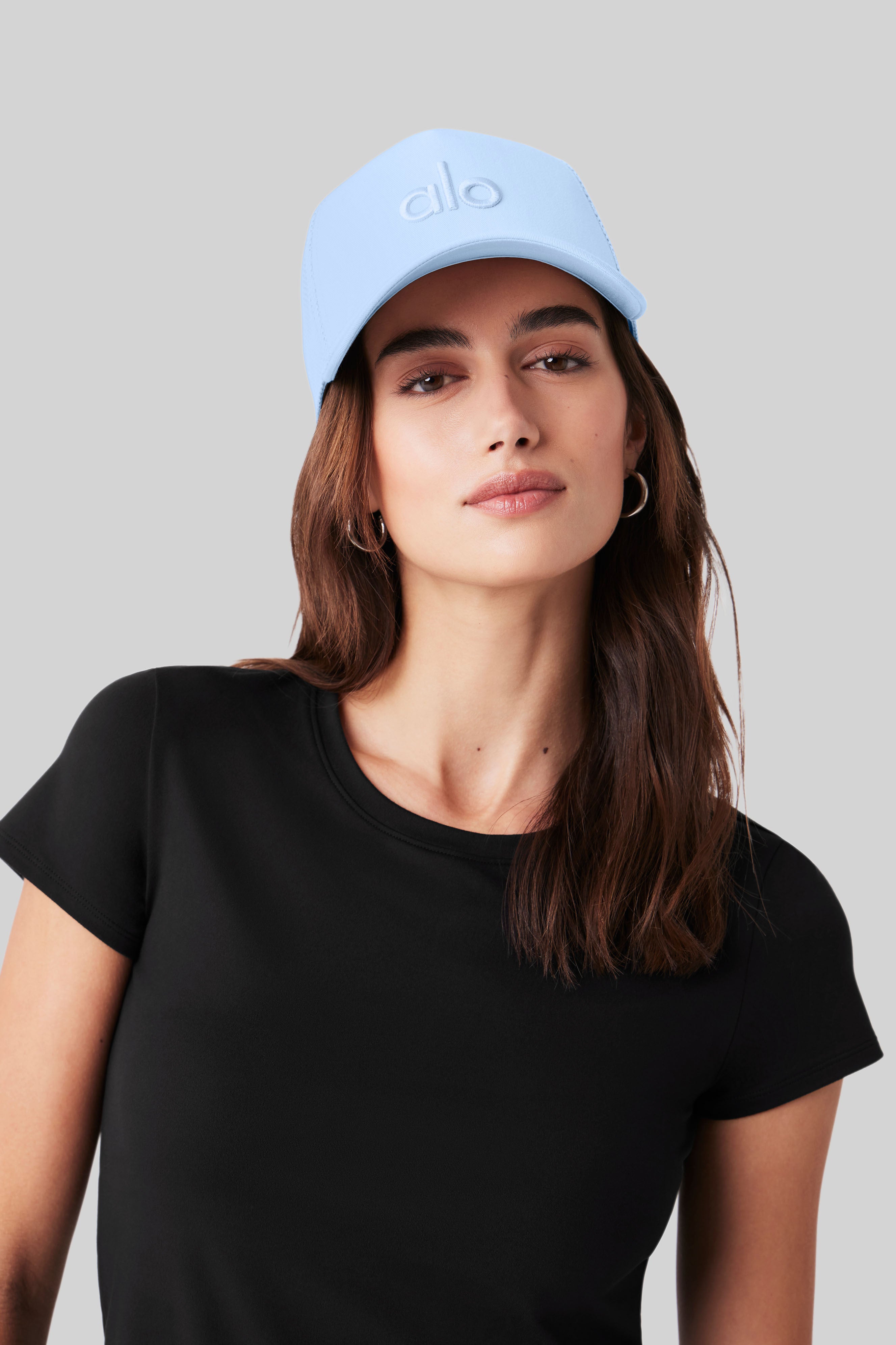 Front view of Seashell Blue trucker hat with embroidered logo and mesh back