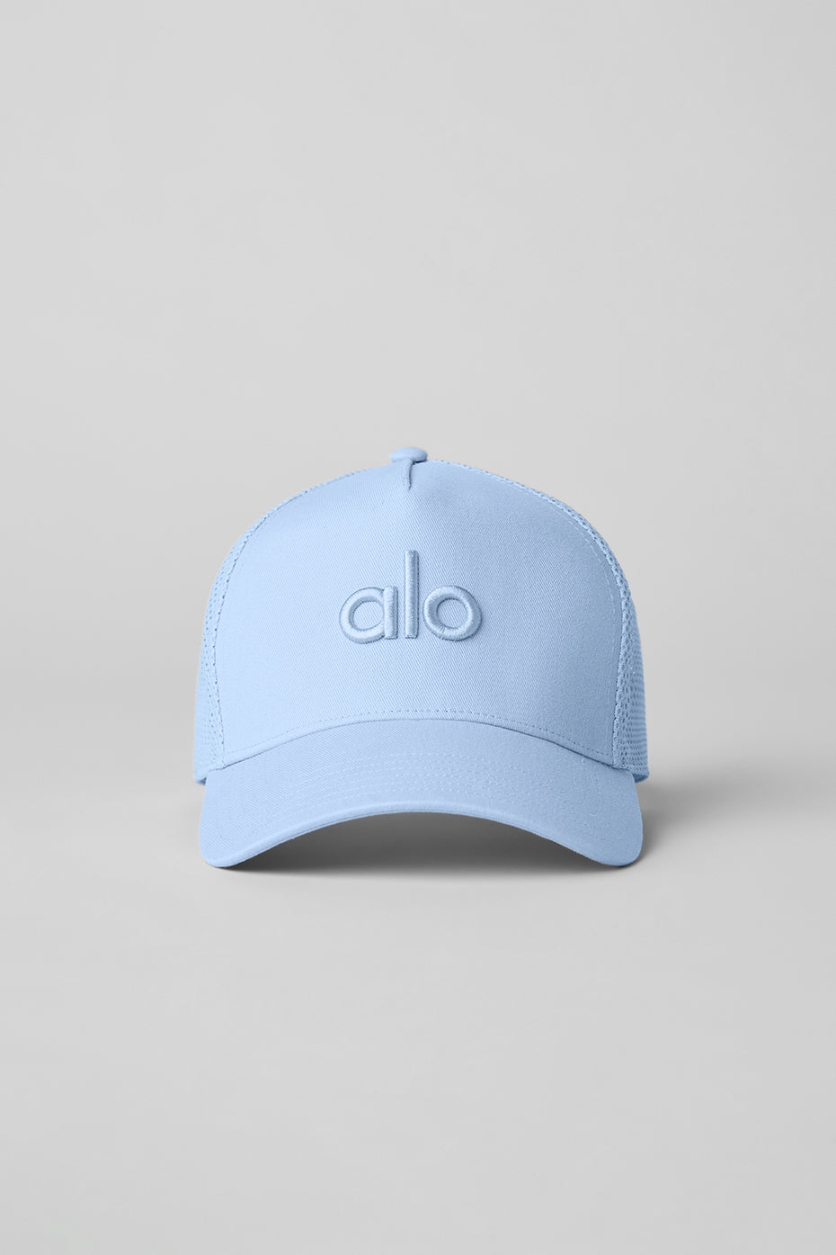 Close-up of adjustable snap closure on black trucker hat
