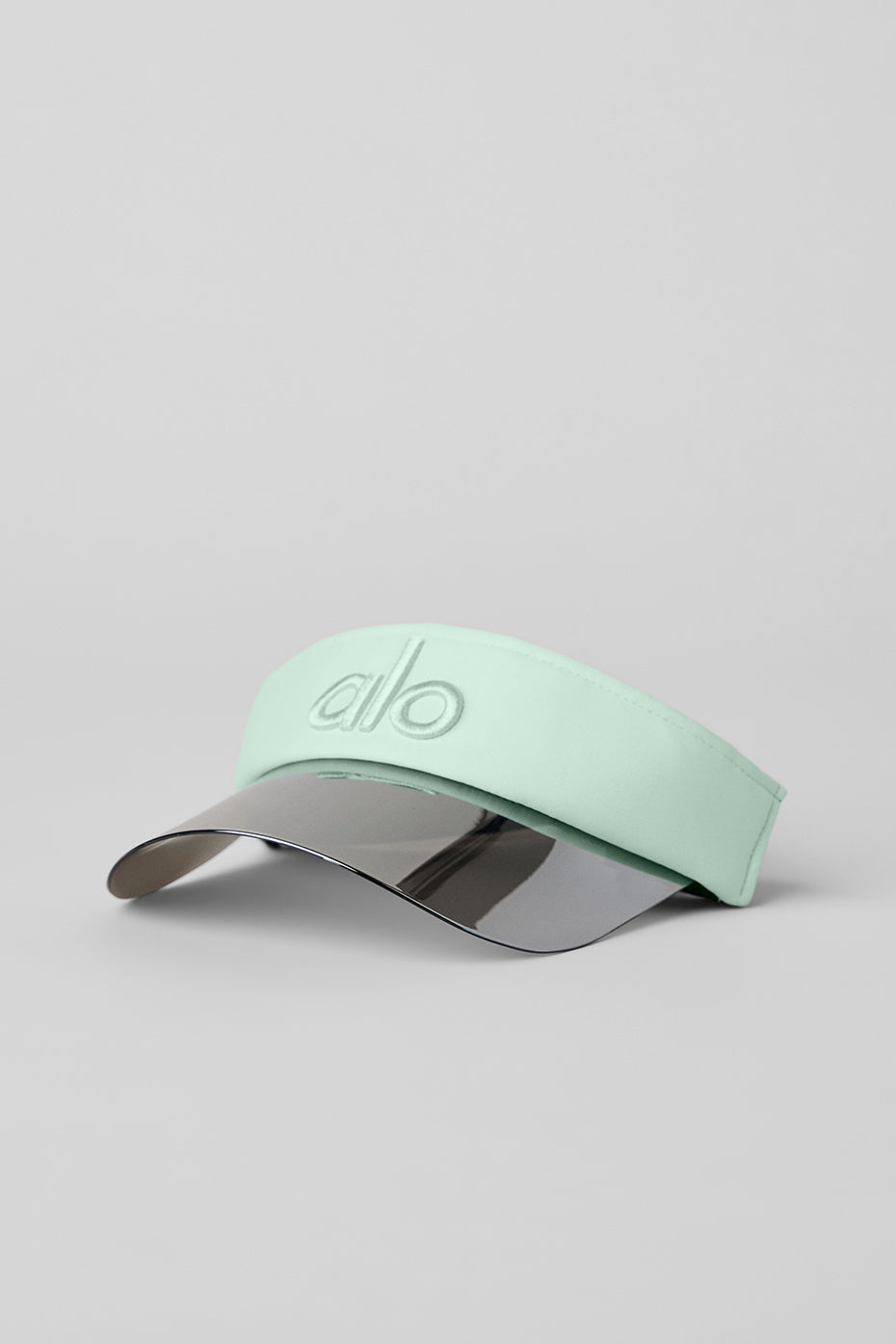 Close-up of spearmint Airlift Solar Visor showing holographic brim and logo detail