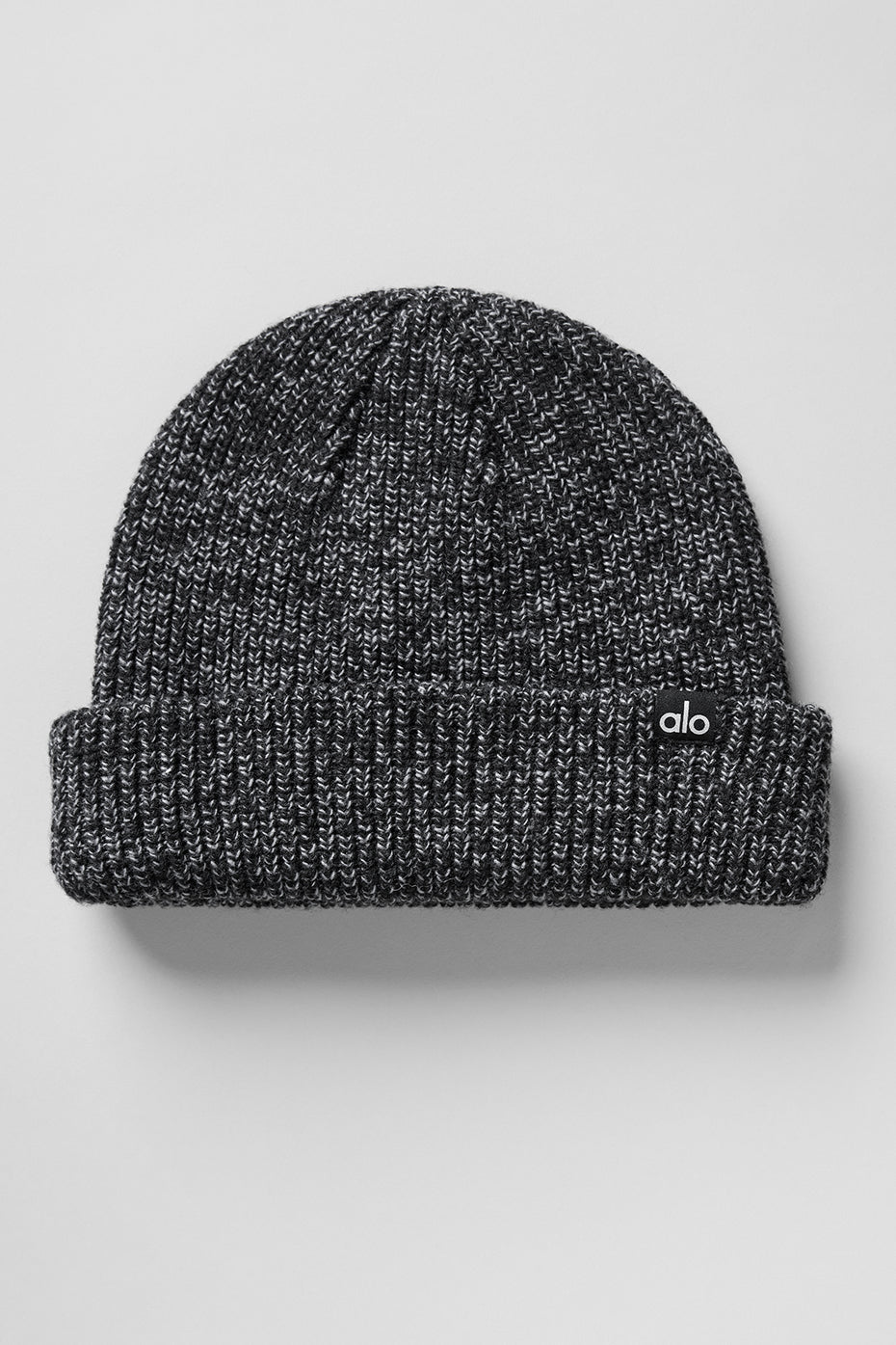 Stylish black marl beanie paired with a winter coat.