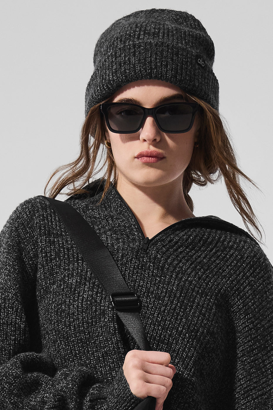 Black marl beanie worn outdoors during winter.