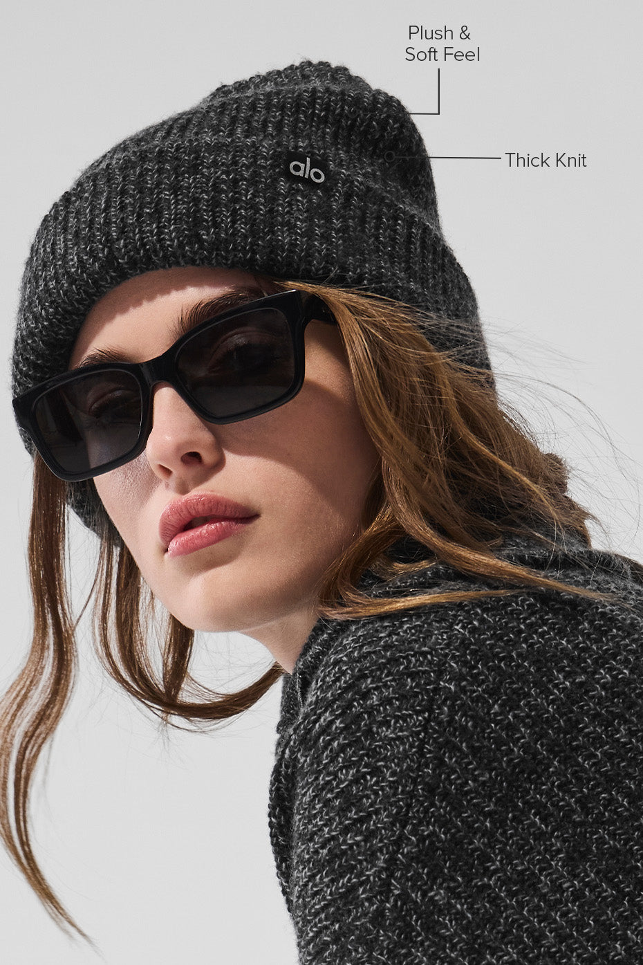 Close-up of the textured wool fabric of the black beanie.