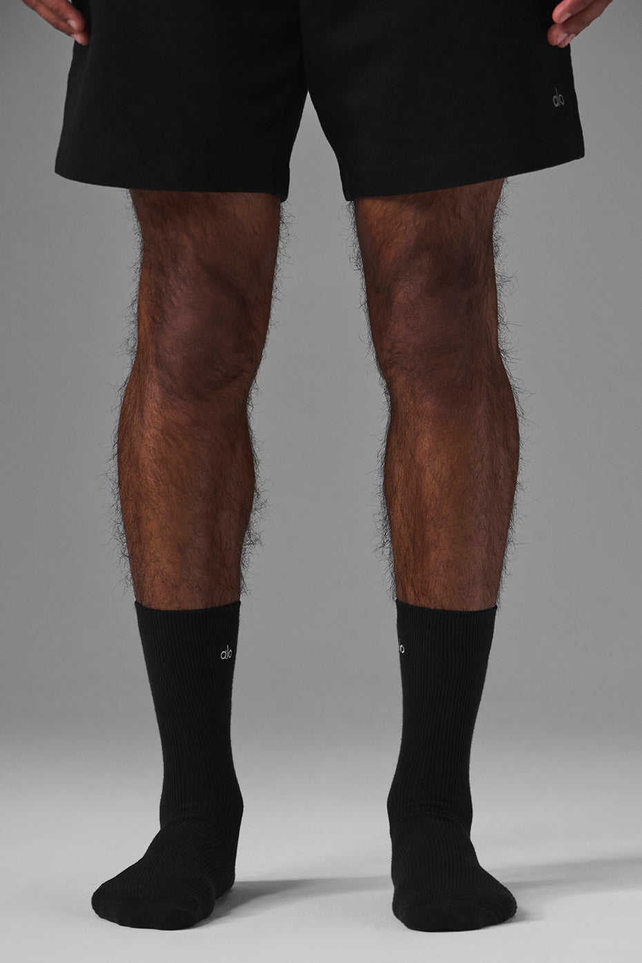 Model wearing black fashion socks with silver logo for casual style
