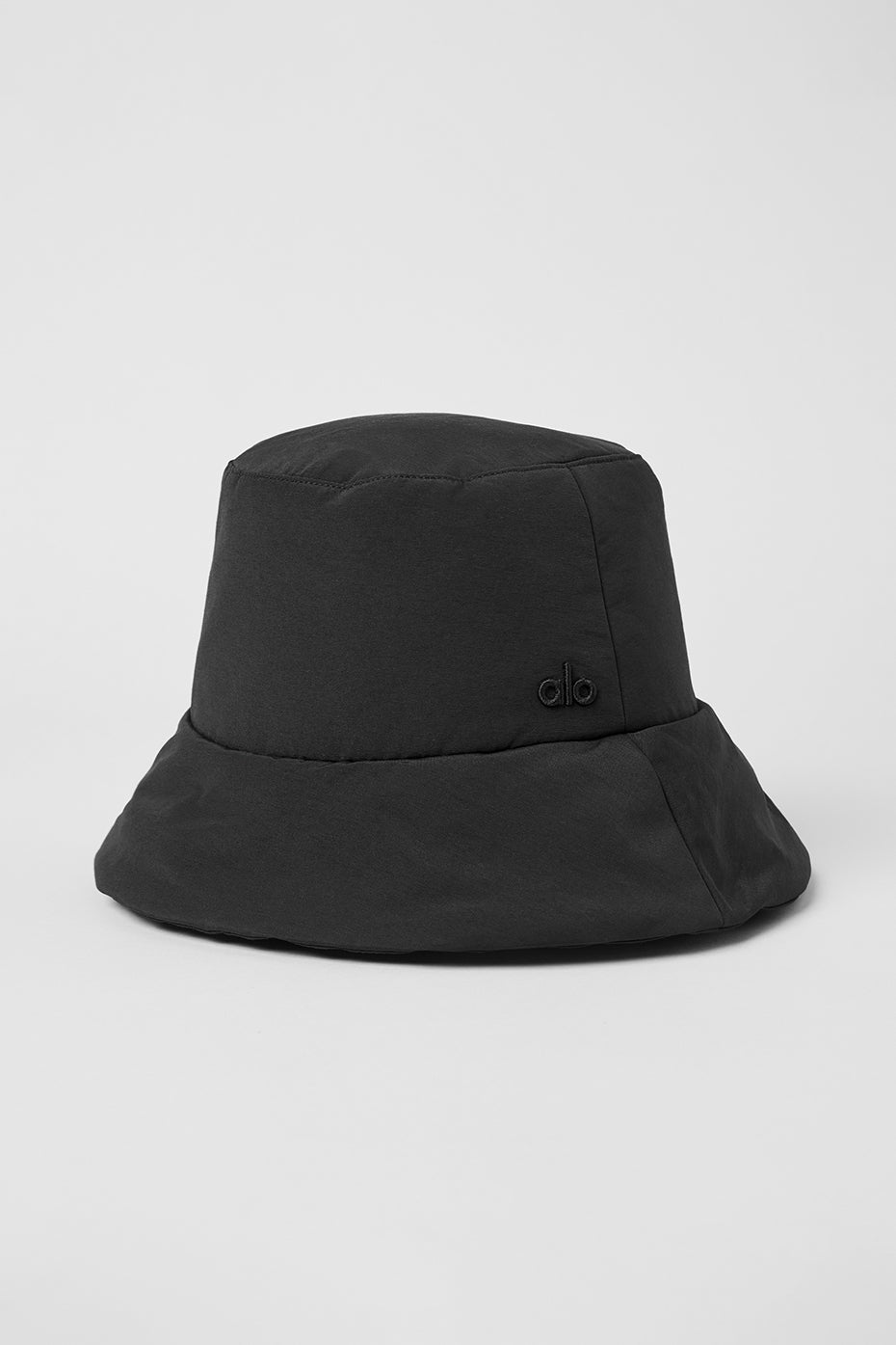 Close-up of black crochet bucket hat showing embroidered logo detail