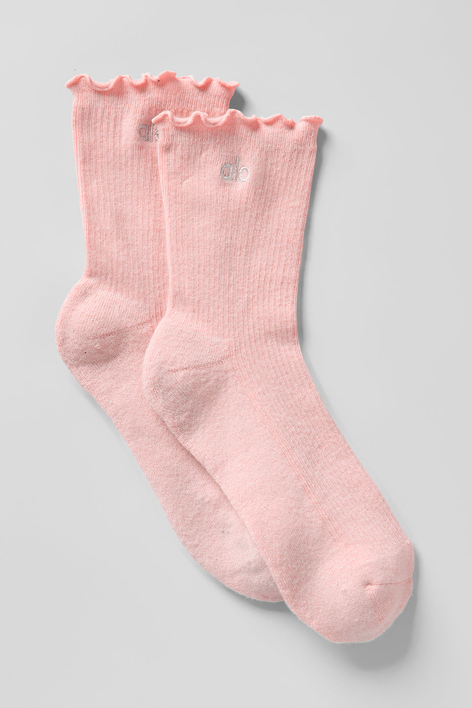 Close-up of pink lace edge socks for women, showing ruffled trim detail