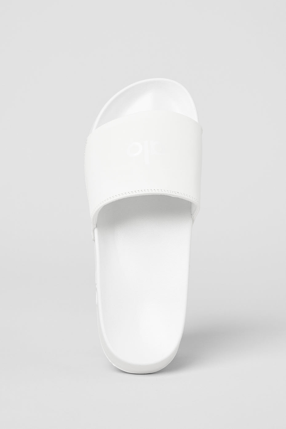 Side view of CloudComfort white slides displaying the foam sole.
