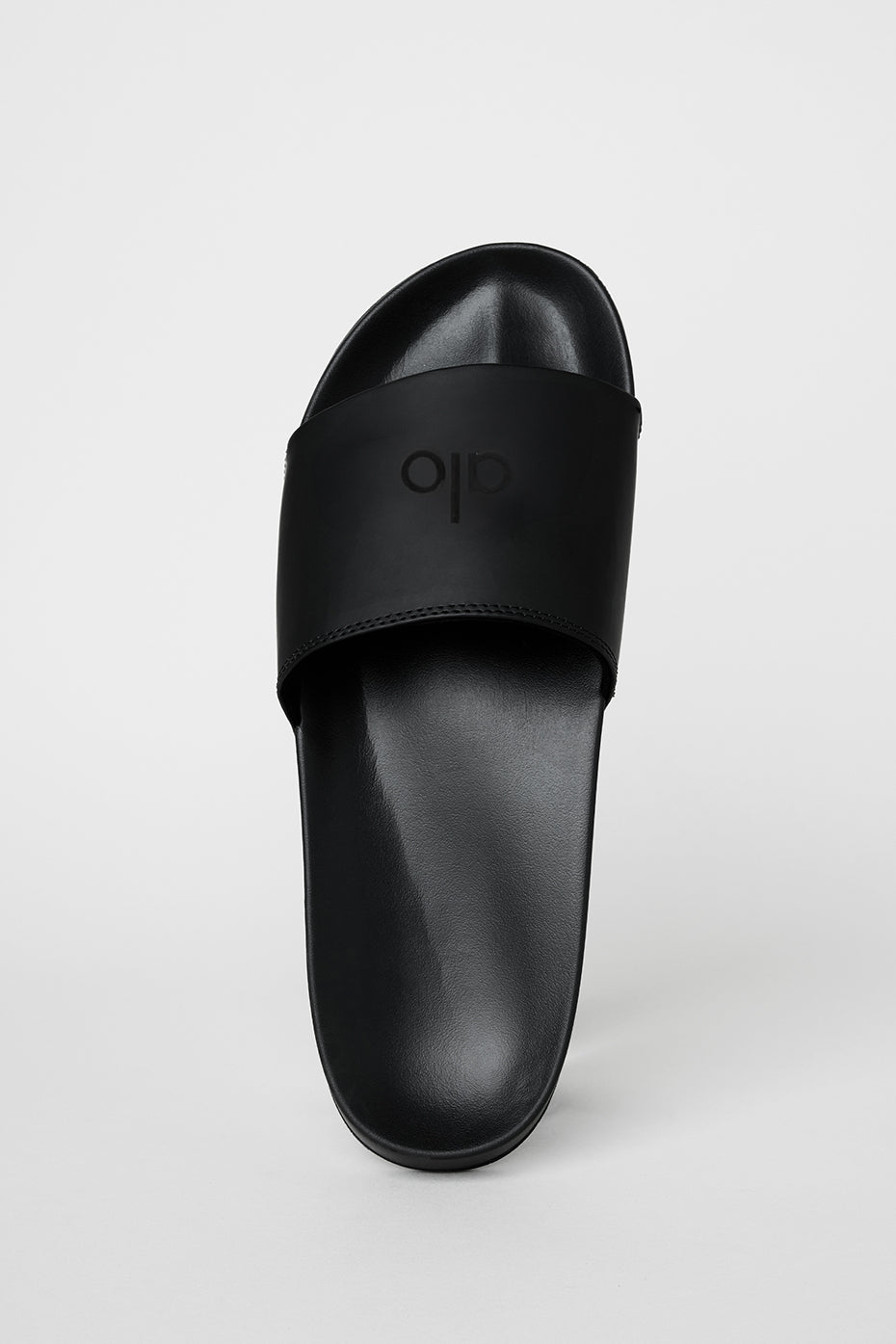 Side view of slip-resistant sole on black slides designed for everyday comfort