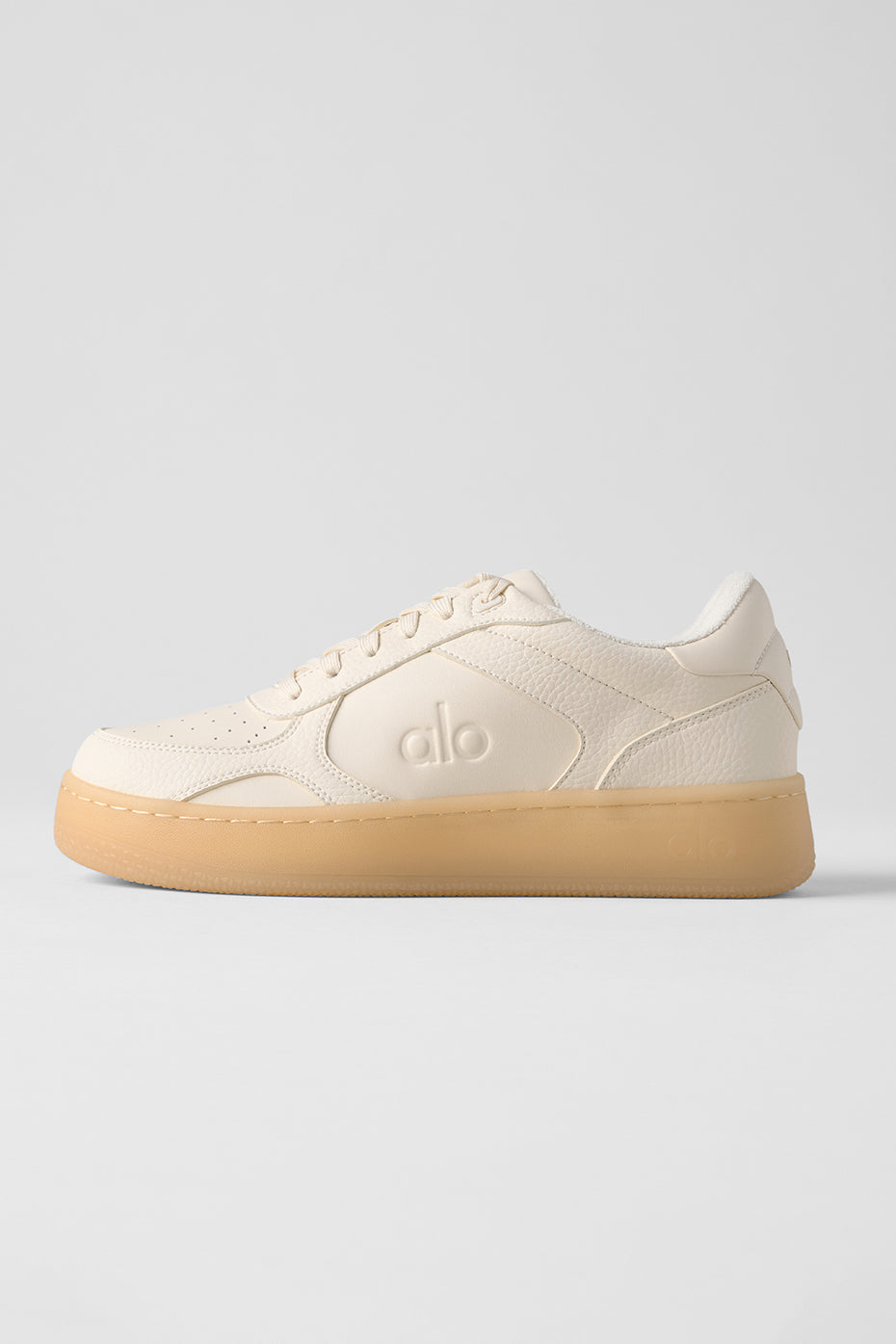 Side view of ALO Recovery Mode Vegan Leather Sneakers in Clay, showcasing modern design.