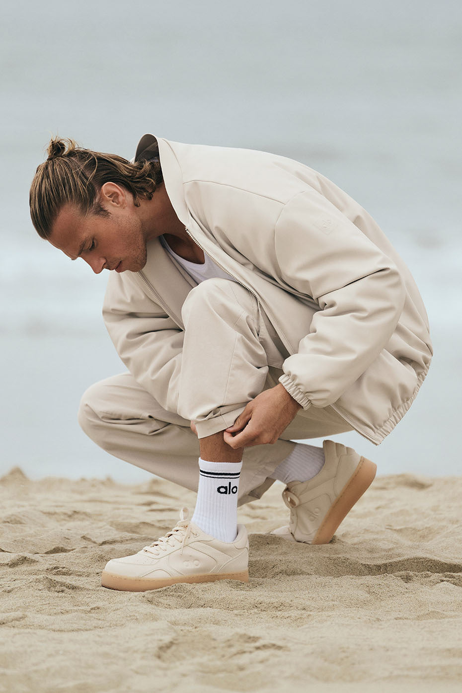 Side view of ALO Recovery Mode Vegan Leather Sneakers in Clay, showcasing modern design.