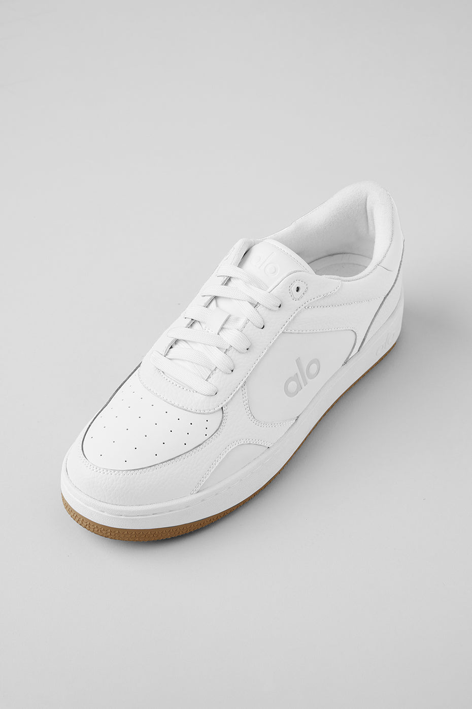Side view of eco-friendly performance recovery sneakers in natural white and gum.