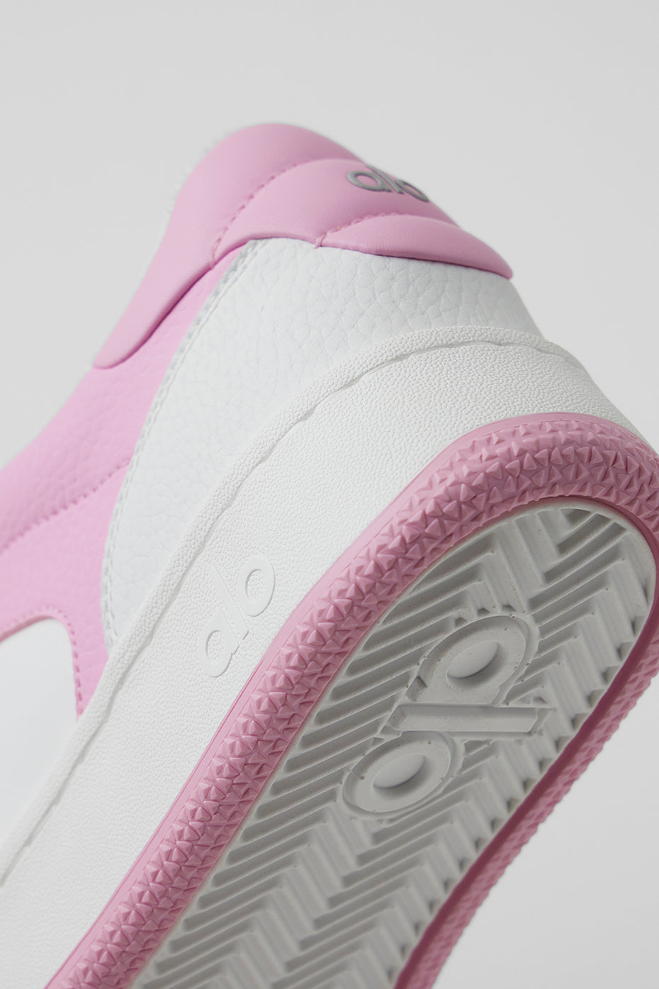 Close-up of the structured sole of ALO Recovery Mode Sneakers for support.