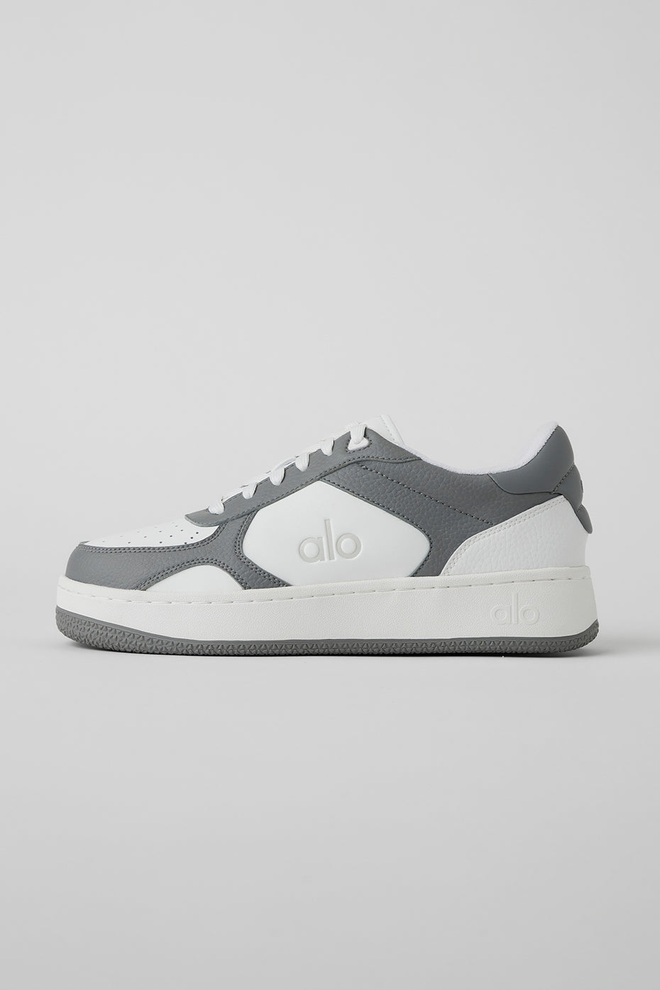 Side view of ALO Recovery Mode vegan sneakers showcasing the grey and white design.