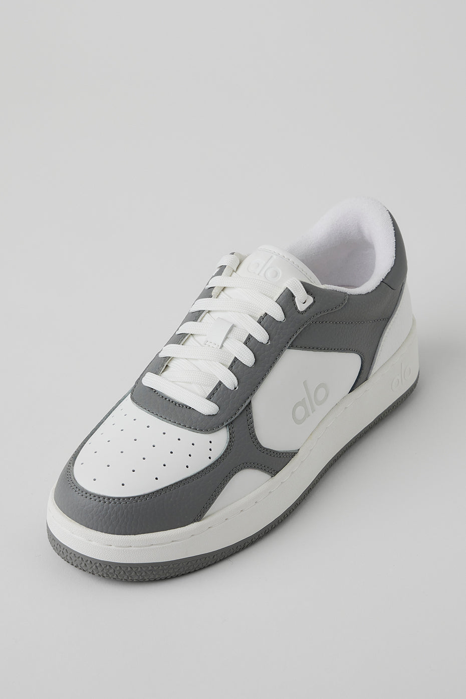 Side view of ALO Recovery Mode vegan sneakers showcasing the grey and white design.